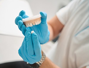 Dentist showing patient how a dental crown works