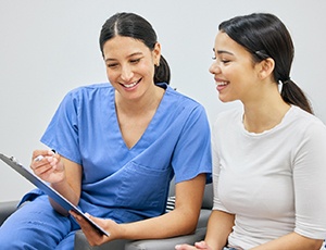 Dental staff member talking to patient