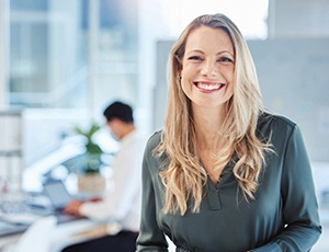 Female professional smiling after seeing her Aetna dentist in Carrollton