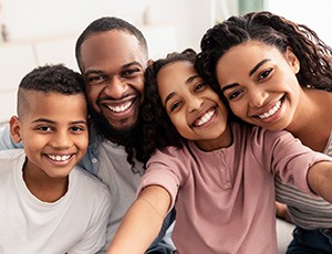 Family showing off smiles from a BlueCross BlueShield dentist in Carrollton