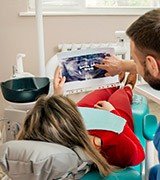 Dentist showing patient dental x-rays