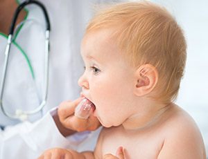 Infant receiving dental exam