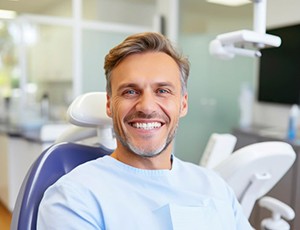 Happy man sitting upright in dental treatment chair