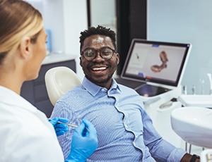 Patient smiling while talking to cosmetic dentist at consultation