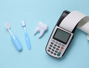 Calculating next to fake tooth and dental hygiene tools