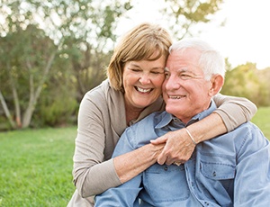 Senior couple smiling with dental crowns in Carrollton