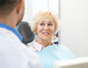 patient smiling while visiting dentist 