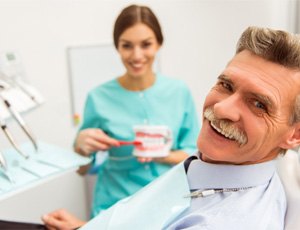 patient smiling after paying cost of dentures in Carrollton