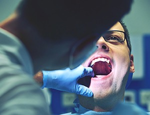 Man getting emergency dental care in Carrollton