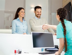 patients speaking with the front desk about dental insurance