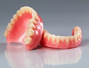 full dentures against a gray background