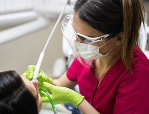  a dental hygienist giving a deep cleaning to a patient