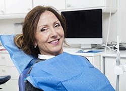 Woman with brown hair smiling in the dental chair