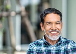 smiling man in a blue plaid shirt