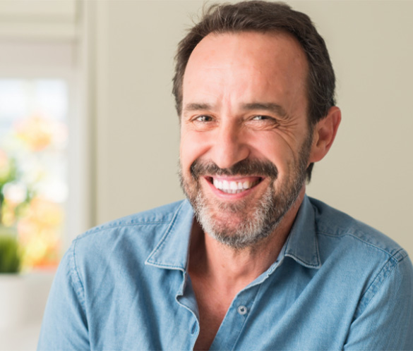 man smiling after dental implants
