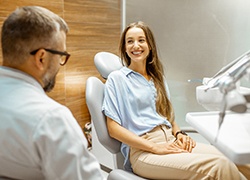 Female patient smiling at dentist at dental appointment