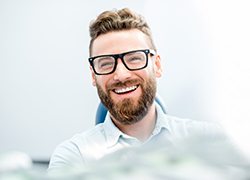 Smiling man sitting in dental office