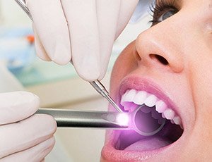 Woman receiving oral cancer screening