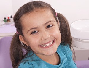 Smiling little girl in dental chair