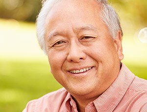 Older man smiling outdoors