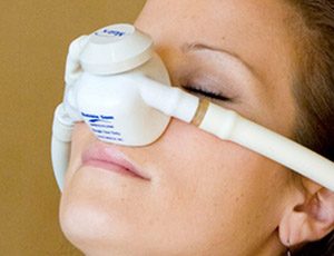 Woman with nitrous oxide nose mask