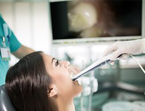 Dentist and patient looking at intraoral photos