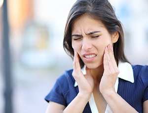 Woman with jaw pain due to TMJ disorder in Carrollton, TX