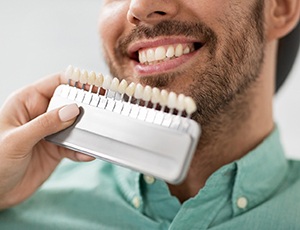 man smiling after getting veneers in Carrollton 