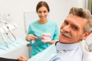 Smiling man with new dentures
