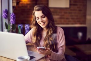 Woman smiling on her phone