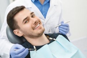 man smiling while visiting dentist in Carrollton