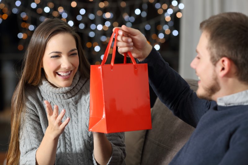 person giving partner Valentine’s Day dental gifts