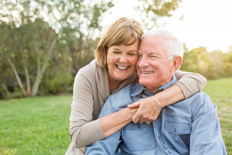 Couple smiling outside