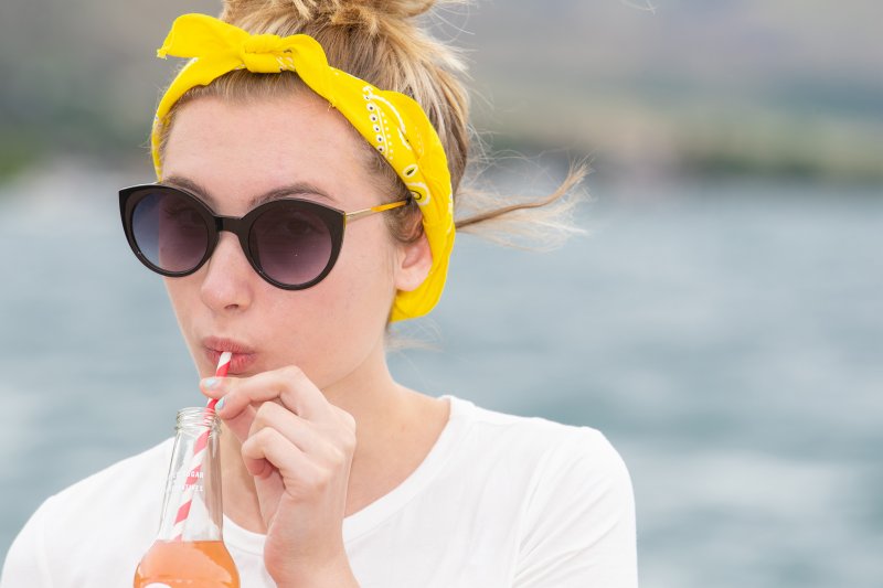 woman drinking with straw during summer in Carrollton