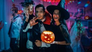 A family smiling and enjoying a Halloween party