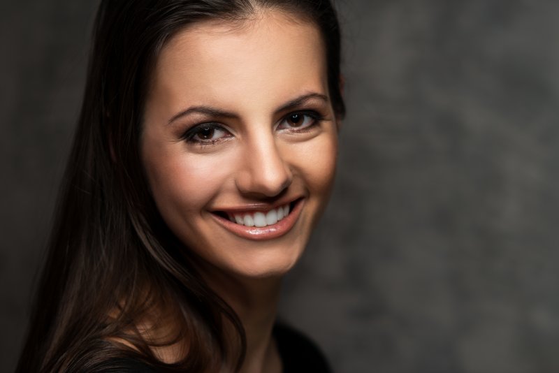 a woman smiling with gray teeth in Carrollton