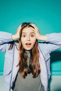 Panicked woman with her hands on head