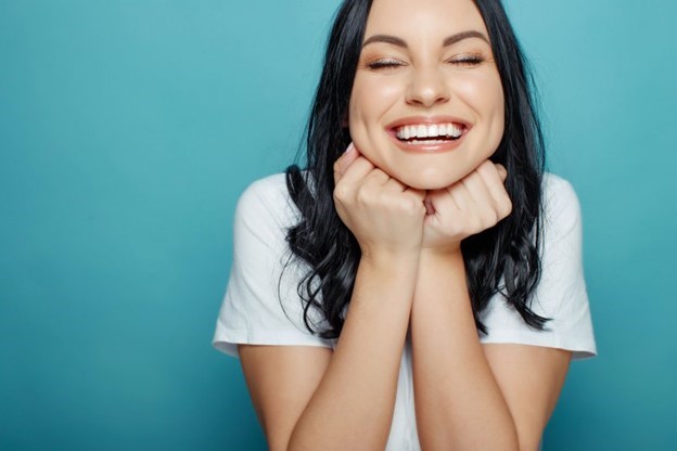 patient smiling after getting dental implant surgery