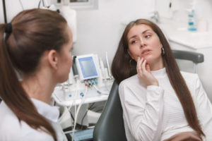 Woman in pain at an emergency dentist