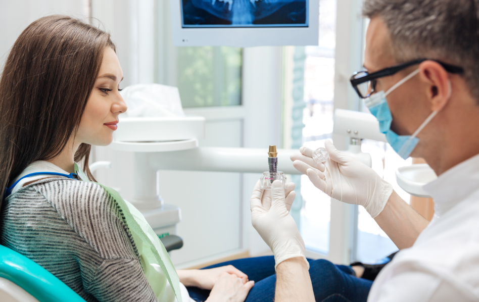 Dentist showing patient dental implant