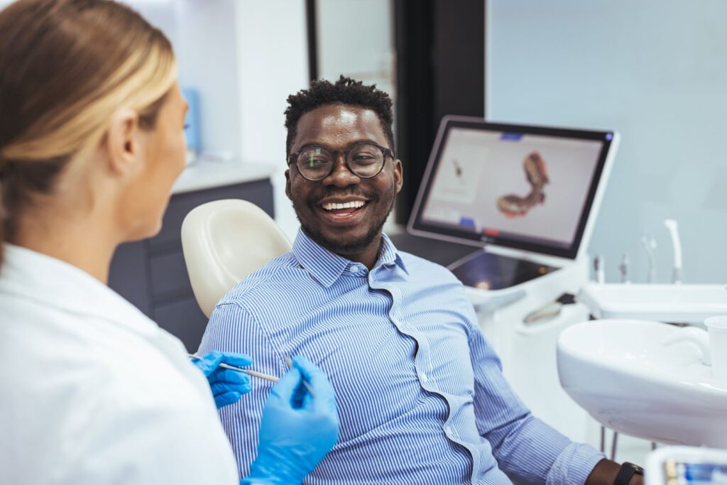 A man smiling at the dentist