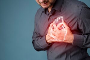 Man holding both hands over his heart.